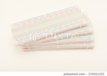 A solderless board for electronics. A breadboard for experiments in electronics. A solderless board for electronics. A breadboard for experiments in electronics. 135022281