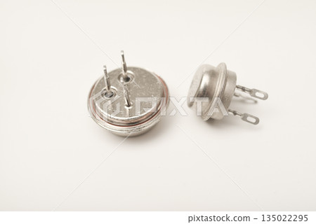 An old bipolar transistor. A bipolar transistor in a metal case. A powerful transistor. An old bipolar transistor. A bipolar transistor in a metal case. A powerful transistor. 135022295