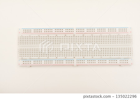 A solderless board for electronics. A breadboard for experiments in electronics. 135022296