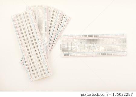 A solderless board for electronics. A breadboard for experiments in electronics. A solderless board for electronics. A breadboard for experiments in electronics. 135022297