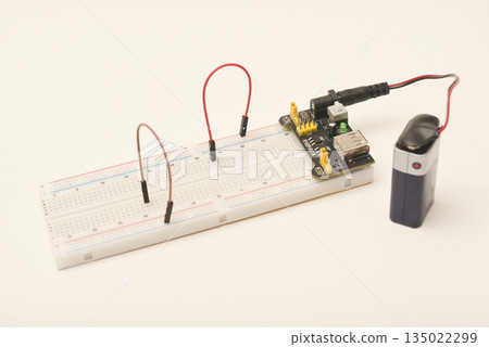 A solderless board for electronics with a battery. A breadboard for experiments in electronics. A solderless board for electronics with a battery. A breadboard for experiments in electronics. 135022299