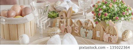 Festive Easter table setting with Easter bunny made from napkin. Easter celebration concept 135022364