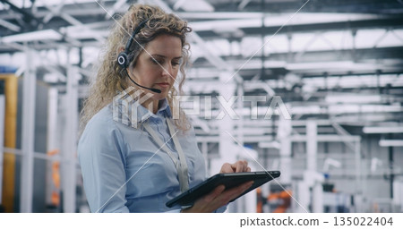 Focused Female Technical Specialist Conducting Digital Diagnostics in Industry 4.0 Facility Focused Female Technical Specialist Conducting Digital Diagnostics in Industry 4.0 Facility 135022404