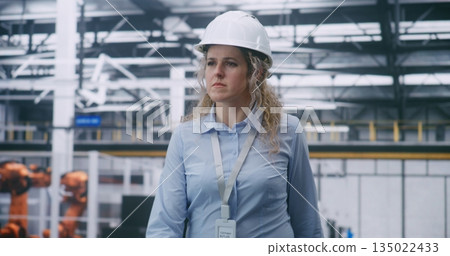 Factory Floor Management, Female Engineer Wearing White Hard Hat and Checking Data Factory Floor Management, Female Engineer Wearing White Hard Hat and Checking Data 135022433