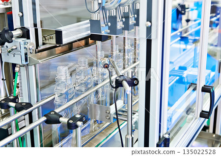 Plastic bottles in filling machine 135022528