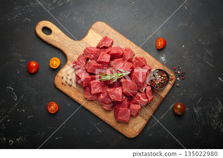 Diced cut raw beef cubes wooden cutting board red meat cooking protein top view Diced cut raw beef cubes wooden cutting board red meat cooking protein top view 135022980