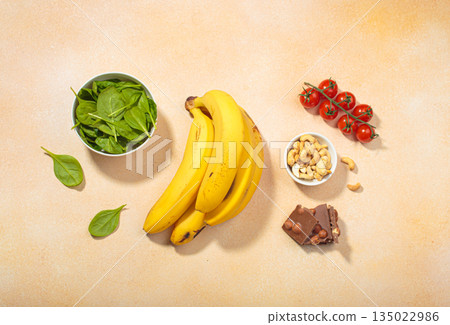 Magnesium rich foods healthy diet nutrition banana spinach nuts chocolate tomatoes 135022986