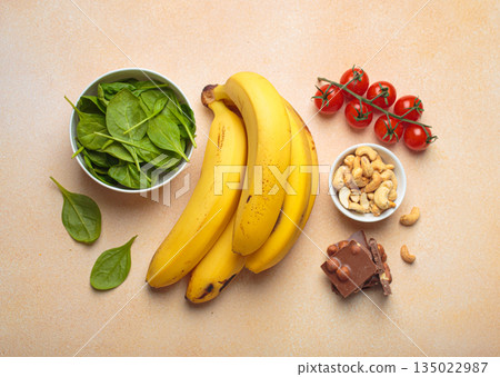 Magnesium rich foods healthy diet nutrition banana spinach nuts chocolate tomatoes Magnesium rich foods healthy diet nutrition banana spinach nuts chocolate tomatoes 135022987