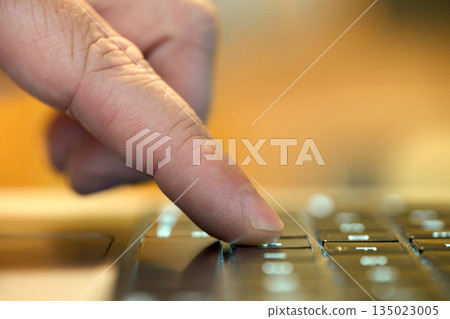 Finger pressing key on laptop keyboard Finger pressing key on laptop keyboard 135023005