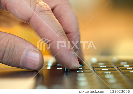 Hand typing on a keyboard while working Hand typing on a keyboard while working 135023006