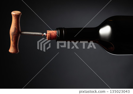 Bottle of wine and old corkscrew. Bottle of wine and old corkscrew. 135023043