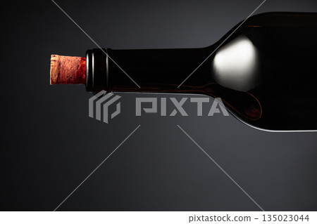 An almost opened bottle of red wine. An almost opened bottle of red wine. 135023044