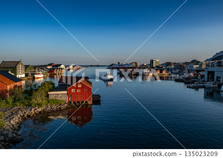 Harbor And Rorbuer Huts At Midnight Sun In Svolvaer City On Lofoten Islands In Norway Harbor And Rorbuer Huts At Midnight Sun In Svolvaer City On Lofoten Islands In Norway 135023209