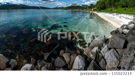 White Sand Beach And Snowy Mountains At The Fjord Cost Of Lofoten Islands In Norway White Sand Beach And Snowy Mountains At The Fjord Cost Of Lofoten Islands In Norway 135023214