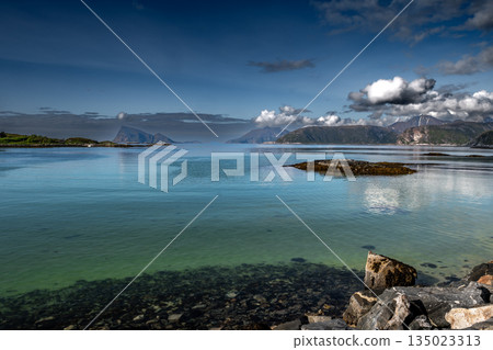 Coastal Landscape With Calm Fjord And Snowy Mountains At Sommaroy In Norway 135023313