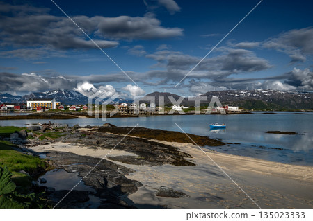 Coastal Landscape With Calm Fjord, Snowy Mountains With Wind Turbines And Cottages On Sommaroy Island  In Norway 135023333