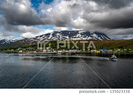 Coastal Landscape Of Village Botnhamn With Snowy Mountains And Harbor On Senja Island In Norway 135023338