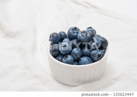 A bowl of ripe blueberries on a white background. 135023447