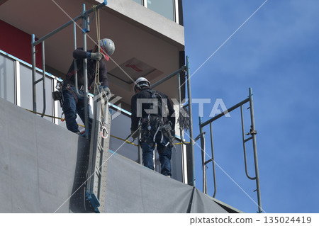 New apartment building construction: Dismantling of temporary scaffolding New apartment building construction: Dismantling of temporary scaffolding 135024419