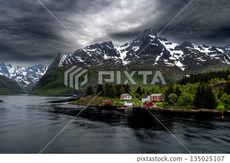 Coastal Landscape With Small Village And Snowy Mountains Near Trollfjord At The Lofoten In Norway Coastal Landscape With Small Village And Snowy Mountains Near Trollfjord At The Lofoten In Norway 135025107