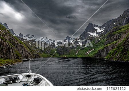 Cruise Ship Approaches High Bridge Over Calm Fjord Near Stokmarknes At The Lofoten In Norway 135025112