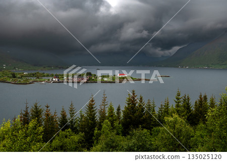 Rural Landscape With Remote Village, Calm Fjord And Foggy Mountains On Lofoten Islands In Norway 135025120