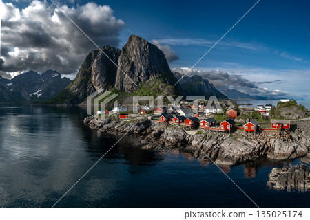 Picturesque Coastal Village Hamnoy With Red Rorbuer Huts On Lofoten Islands In Norway Picturesque Coastal Village Hamnoy With Red Rorbuer Huts On Lofoten Islands In Norway 135025174