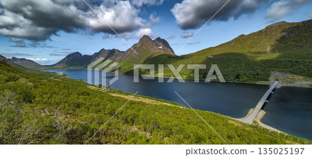 Bridge Over Narrow Fjord At Gryllefjord Village With Ferry Terminal On Senja Island At Vesteralen In Norway 135025197