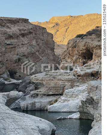 Wadi Bani Khalid is a popular Omani oasis featuring large, swimmable emerald-green pools and canyon landscapes in Oman. A Desert Paradise with Serene Water Pools and Stunning Canyons 135025489