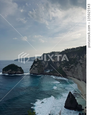 Nusa Penida, Indonesia, rocks, ocean, baliviolent sea battling against rugged shoreline features, stormdriven seascape highlighting tumultuous waters and uneven rocky coastal formations, tempestuous Nusa Penida, Indonesia, rocks, ocean, baliviolent sea battling against rugged shoreline features, stormdriven seascape highlighting tumultuous waters and uneven rocky coastal formations, tempestuous 135025543