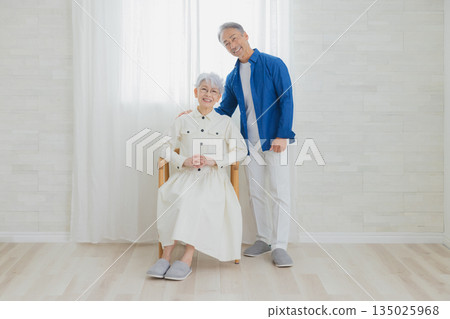 Smiling senior couple in the living room 135025968