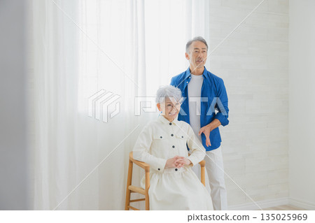 Smiling senior couple in the living room 135025969