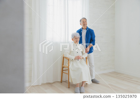 Smiling senior couple in the living room 135025970