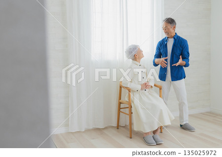 Smiling senior couple in the living room Smiling senior couple in the living room 135025972