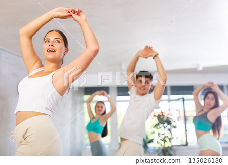 Group of young women and young guy dance contemporary Group of young women and young guy dance contemporary 135026180