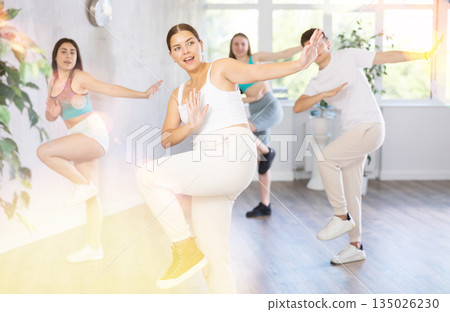 Teenagers practicing breakdance toprock moves in training hall. Teenagers engaged in breakdance 135026230