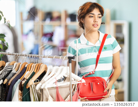 Young women choosing handbag in store 135026357