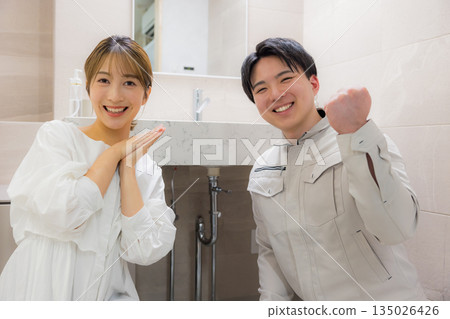 一名身穿工作服的男子和一名前來尋求維修服務的女子 135026426