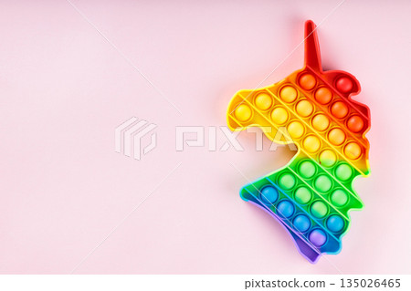 Rainbow Unicorn Pop It Fidget Toy on Pink Background with Copy Space Sensory Anti Stress Concept Rainbow Unicorn Pop It Fidget Toy on Pink Background with Copy Space Sensory Anti Stress Concept 135026465