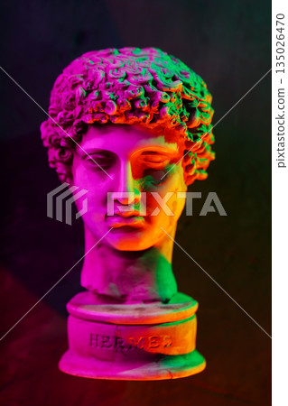 Classical Hermes Sculpture Bust Illuminated with Vibrant Neon Pink Orange Green Gradient Lighting 135026470