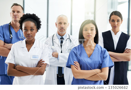Healthcare, crossed arms and portrait of team of doctors standing in the hallway with confidence. Serious, diversity and group of medical workers in the corridor of a medicare clinic or hospital. Healthcare, crossed arms and portrait of team of doctors standing in the hallway with confidence. Serious, diversity and group of medical workers in the corridor of a medicare clinic or hospital. 135026682