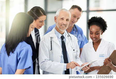 Senior doctor, team or group with tablet, smile and portrait for leadership, discussion or planning together in hospital. Medic man, mentor and medical student with teamwork, women and healthcare job 135026690