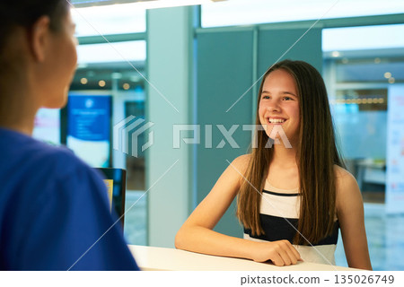 Help, reception and nurse with patient in hospital for advice, medical and information. Medicine, happy and healthcare with teenage girl at desk in clinic for nursing, waiting room and service Help, reception and nurse with patient in hospital for advice, medical and information. Medicine, happy and healthcare with teenage girl at desk in clinic for nursing, waiting room and service 135026749