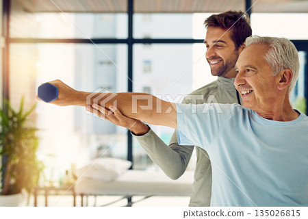 Happy, weights and a man with a physiotherapist for exercise, fitness rehabilitation and wellness. Smile, support and a senior patient with a doctor or coach for weightlifting and training for health Happy, weights and a man with a physiotherapist for exercise, fitness rehabilitation and wellness. Smile, support and a senior patient with a doctor or coach for weightlifting and training for health 135026815