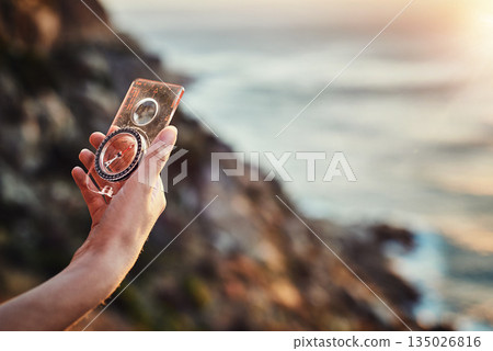 Travel, compass and hand for navigation or finding path or out for hike in summer and mountain journey on bokeh. Directions, lost and search for a route or magnetic or nature and vacation adventure 135026816