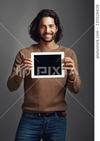 Portrait, tablet screen and smile of man with mockup in studio isolated on a gray background. Touchscreen, face and male person with marketing, advertising and technology for commercial promotion. Portrait, tablet screen and smile of man with mockup in studio isolated on a gray background. Touchscreen, face and male person with marketing, advertising and technology for commercial promotion. 135026838