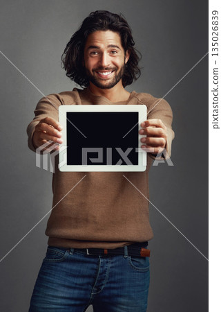 Tablet screen, portrait and smile of man with mockup in studio isolated on a gray background. Touchscreen, face and male person with marketing, advertising and technology for commercial promotion. Tablet screen, portrait and smile of man with mockup in studio isolated on a gray background. Touchscreen, face and male person with marketing, advertising and technology for commercial promotion. 135026839