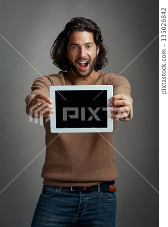 Portrait, tablet screen and excited man with mockup in studio isolated on a gray background. Touchscreen, face and male person with marketing, advertising and technology for surprise promotion. Portrait, tablet screen and excited man with mockup in studio isolated on a gray background. Touchscreen, face and male person with marketing, advertising and technology for surprise promotion. 135026842