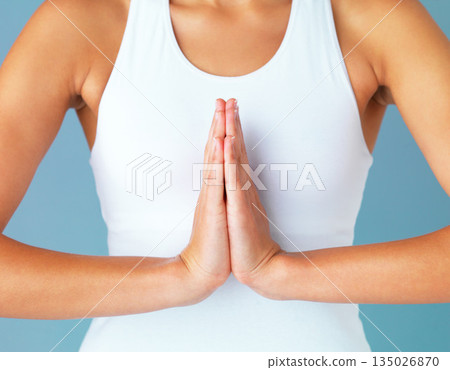 Hands, woman and meditation with prayer and yoga, spiritual and healing with fitness isolated on blue background. Peace, zen and mindfulness, female yogi meditate in studio with closeup and namaste 135026870