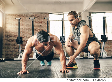 Man, coach and motivation for pushup on gym floor for fitness, health and building muscle for sport. Personal trainer, bodybuilder men and workout with advice, helping hand and together for support 135026896
